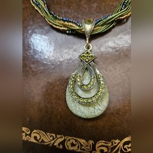 Jade Like embellished pendant with a green beaded necklace.
